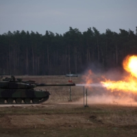 A K2 tank, delivered in the first batch of arms from South Korea under contracts signed in recent months, fires during a drill at a military range near Orzysz, Poland, on Mar. 30. | REUTERS