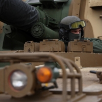 A soldier sits in a K9 howitzer — part of the first batch of South Korean arms delivered to Poland. | REUTERS