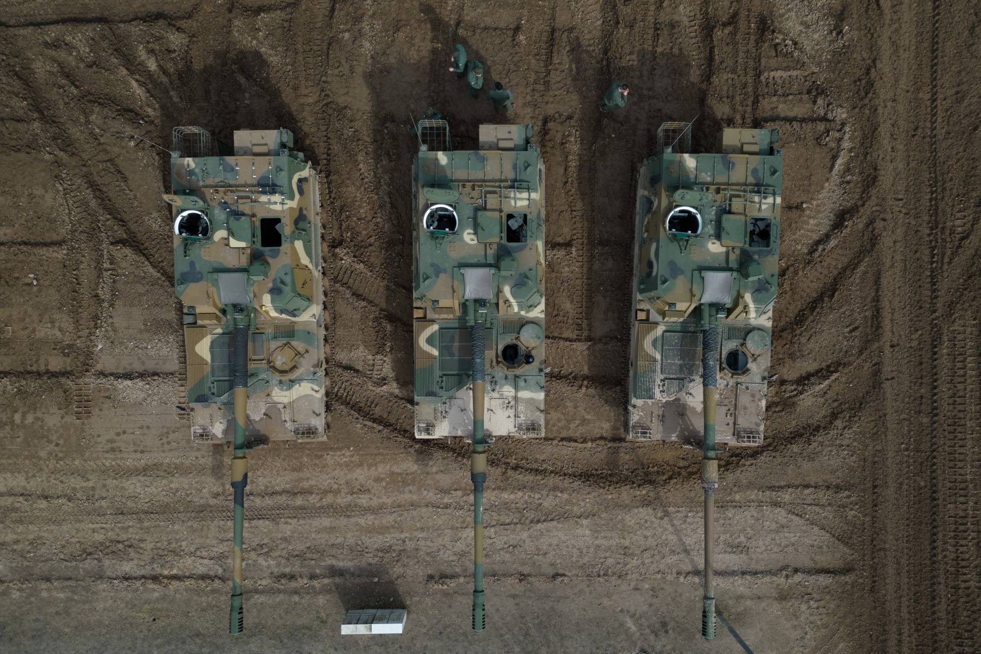 Polish soldiers stand near K9 howitzers, delivered in the first batch of arms from South Korea under contracts signed in recent months, during a military drill at a military range in Wierzbiny near Orzysz, Poland, on Mar. 30. | REUTERS