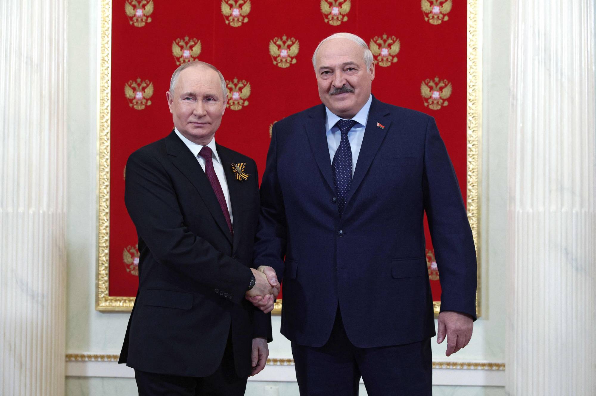 Russian President Vladimir Putin greets Belarus leader Alexander Lukashenko at the Kremlin prior to a Victory Day military parade in central Moscow on May 9. | SPUTNIK / VIA AFP-JIJI