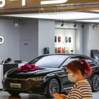 A showroom for BYD, China\'s biggest maker of electric vehicles, in Shanghai on April 10. The intense competition among the country’s huge number of startup carmakers has unsettled what had been a pillar of the economy in recent years. | QILAI SHEN / THE NEW YORK TIMES