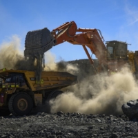 Lithium ore is loaded into mining trucks inside the quarry at the Pilbara Minerals lithium mine in Western Australia, on April 18. Half of the world\'s supply of the critical battery ingredient is mined in Australia, which ships virtually all of it to China. | MATTHEW ABBOTT / THE NEW YORK TIMES