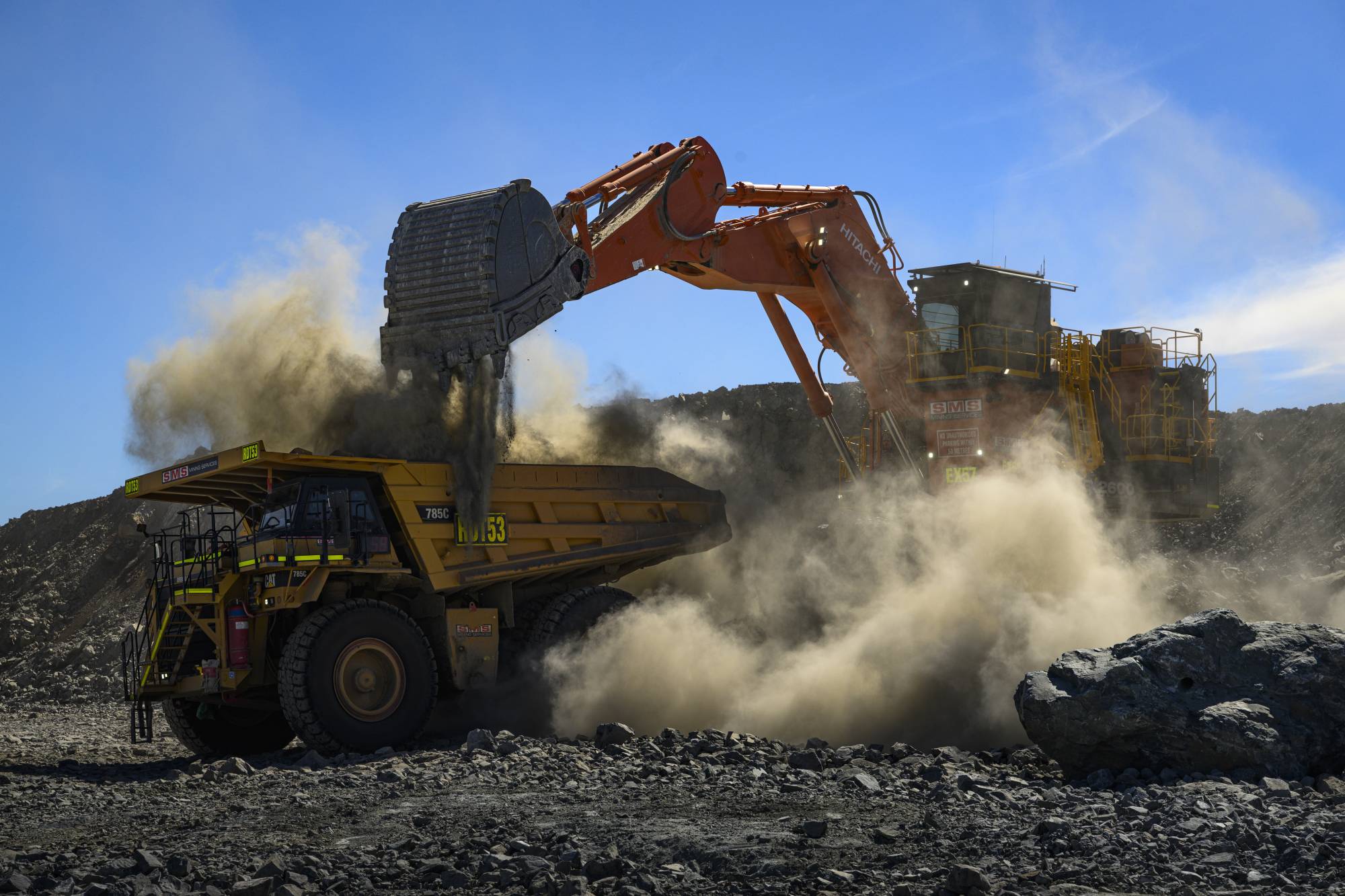 Lithium ore is loaded into mining trucks inside the quarry at the Pilbara Minerals lithium mine in Western Australia, on April 18. Half of the world's supply of the critical battery ingredient is mined in Australia, which ships virtually all of it to China. | Matthew Abbott / The New York Times
