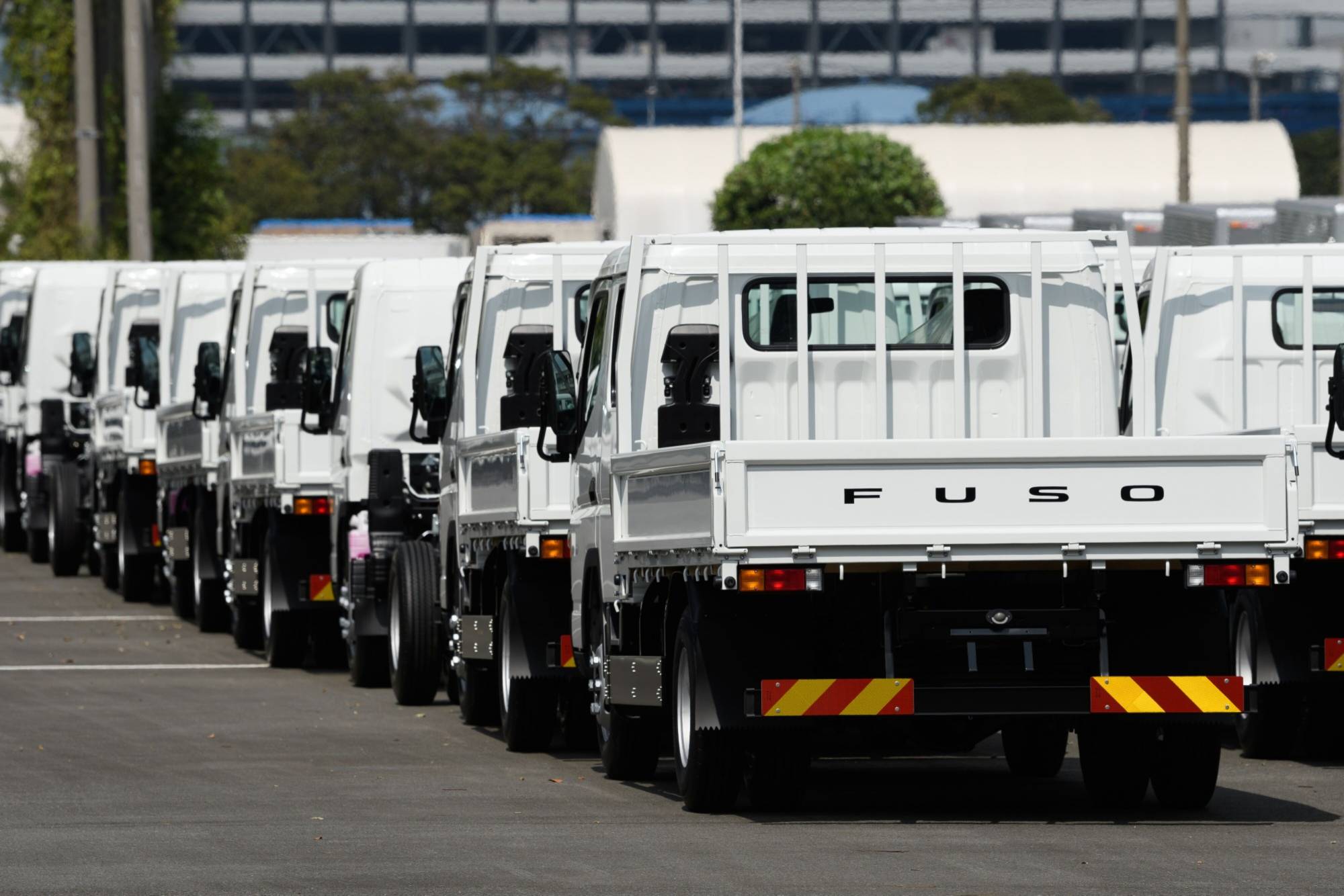 Mitsubishi Fuso Truck and Bus vehicles bound for shipment at Yokohama port | BLOOMBERG