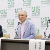 Nippon Foundation Chairman and honorary chair of the Sasakawa Peace Foundation Yohei Sasakawa (center) holds a news conference in Tokyo on Tuesday. | KYODO