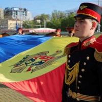 Members of an honor guard hold the Moldovan flag during a ceremony marking the State Flag Day in Chisinau, Moldova, on April 27. | REUTERS