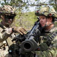 A U.S. soldier instructs a Finnish soldier on the Carl Gustaf recoilless rifle during the Northern Forest land force exercise in Rovajarvi, Finland, on Tuesday. | REUTERS