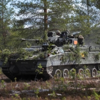 A British Warrior infantry fighting vehicle advances during the Northern Forest land force exercise in Rovajarvi on Tuesday. | REUTERS