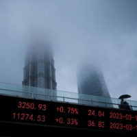 Shanghai and Shenzhen stock indices are displayed in the Lujiazui financial district in Shanghai on March 17. | REUTERS