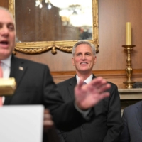 Republican debt limit negotiator Rep. Patrick McHenry (right) and U.S. House Speaker Kevin McCarthy (center) listen to U.S. House Majority Leader Steve Scalise speak in the Rayburn Room following the House vote on the Fiscal Responsibility Act in Washington on Wednesday. | AFP-JIJI