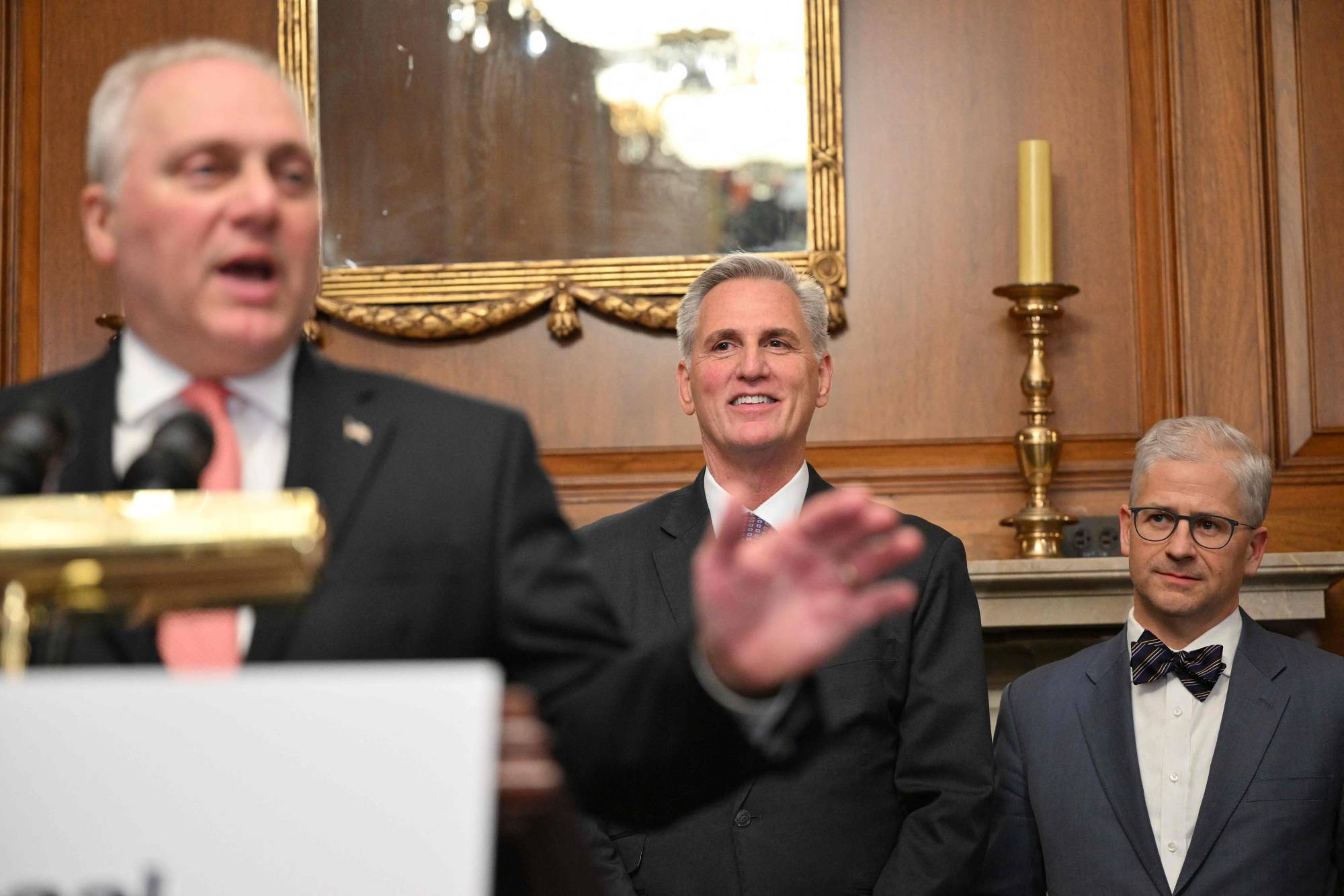Republican debt limit negotiator Rep. Patrick McHenry (right) and U.S. House Speaker Kevin McCarthy (center) listen to U.S. House Majority Leader Steve Scalise speak in the Rayburn Room following the House vote on the Fiscal Responsibility Act in Washington on Wednesday. | AFP-JIJI