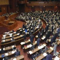 Japan\'s parliament enacted a law Friday to scrap health insurance cards and incorporate them in My Number national identification cards. | KYODO