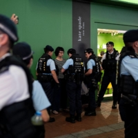 Police stop and search performance artist Chan Meitung before arresting her in Causeway Bay near Victoria Park in Hong Kong on Saturday.  | AFP-JIJI