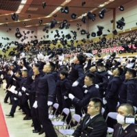 Students toss their hats into the air at the National Defense Academy\'s graduation ceremony in Yokosuka, Kanagawa Prefecture, on March 26. | KYODO