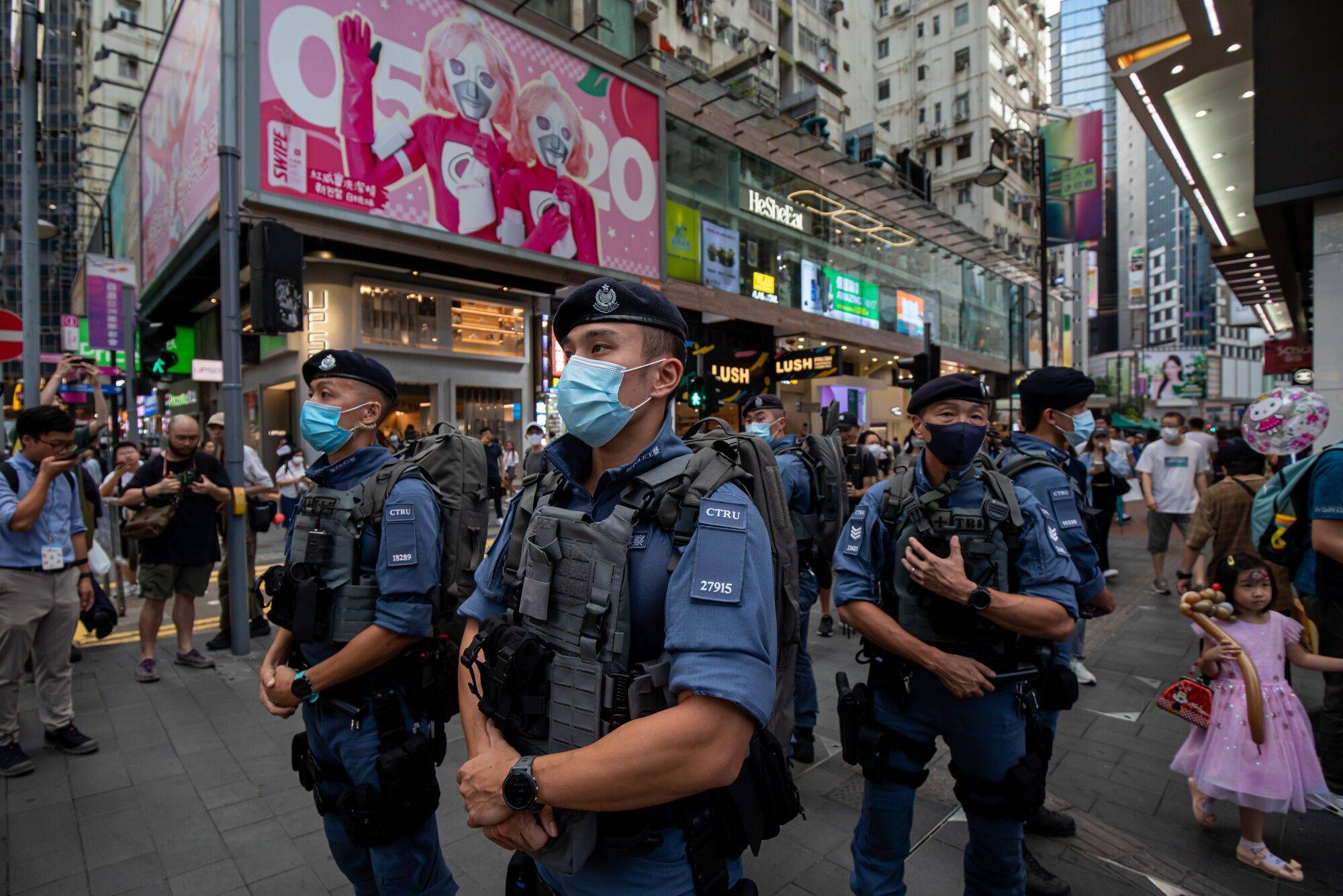 Police officers stand guard at Causeway Bay in Hong Kong on Sunday. For almost three decades, people in Hong Kong commemorated the June 4 anniversary of China's deadly crackdown on protesters in Tiananmen Square with a noisy candlelit vigil in the city's Victoria Park. Not anymore. | BLOOMBERG