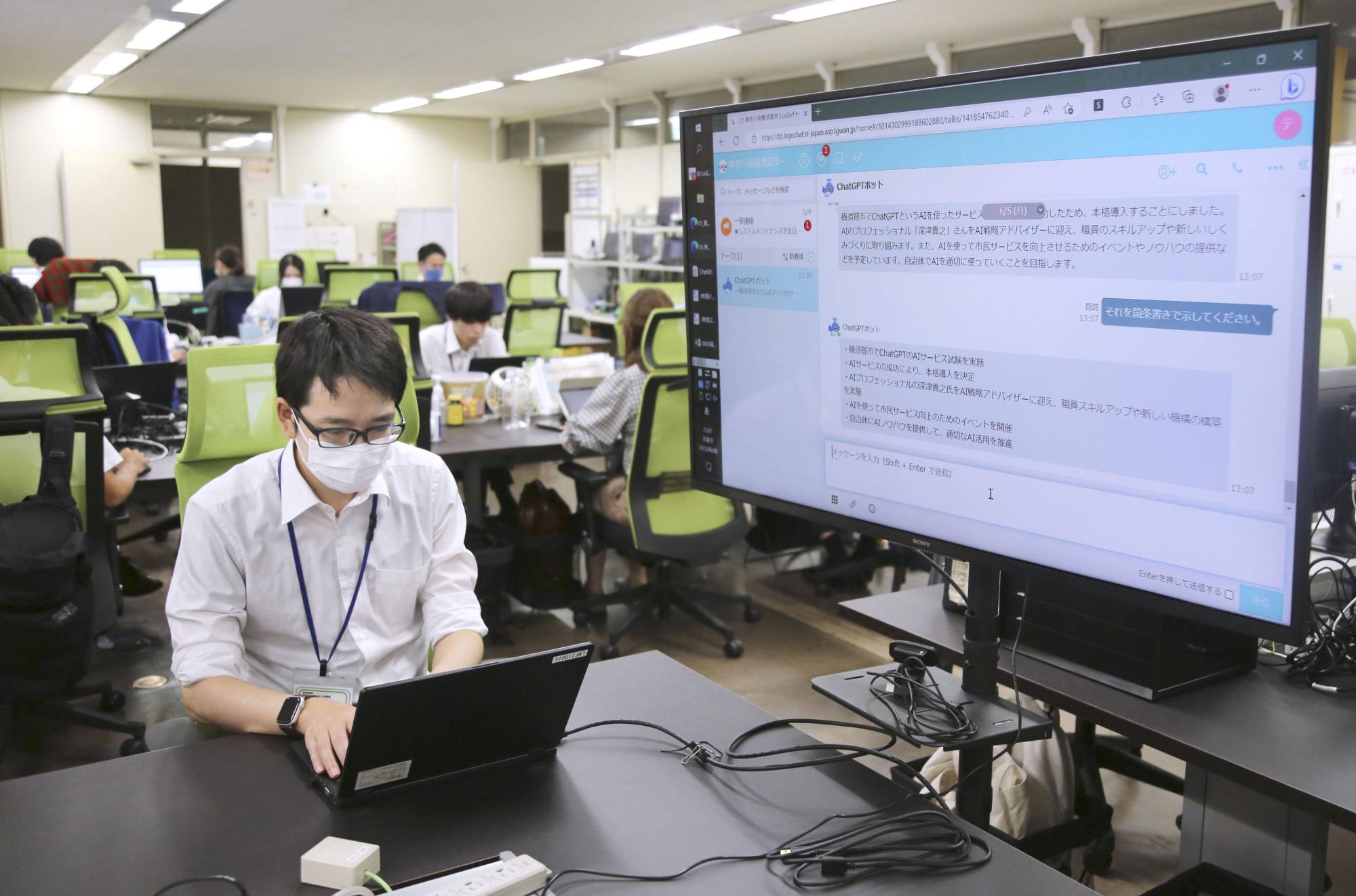 Municipal officials in Yokosuka, Kanagawa Prefecture, use ChatGPT as they work at the city hall on Monday. | KYODO