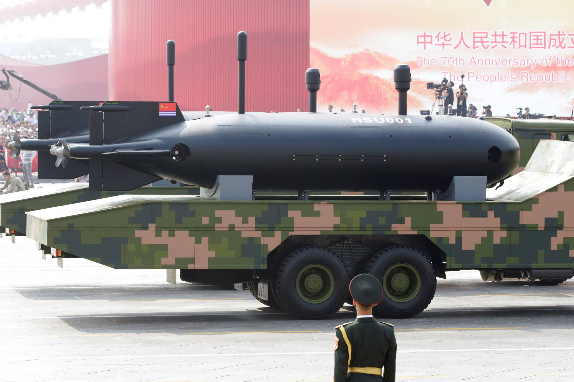 Military vehicles carrying underwater drones travel past Tiananmen Square during a parade in Beijing in 2019. | REUTERS