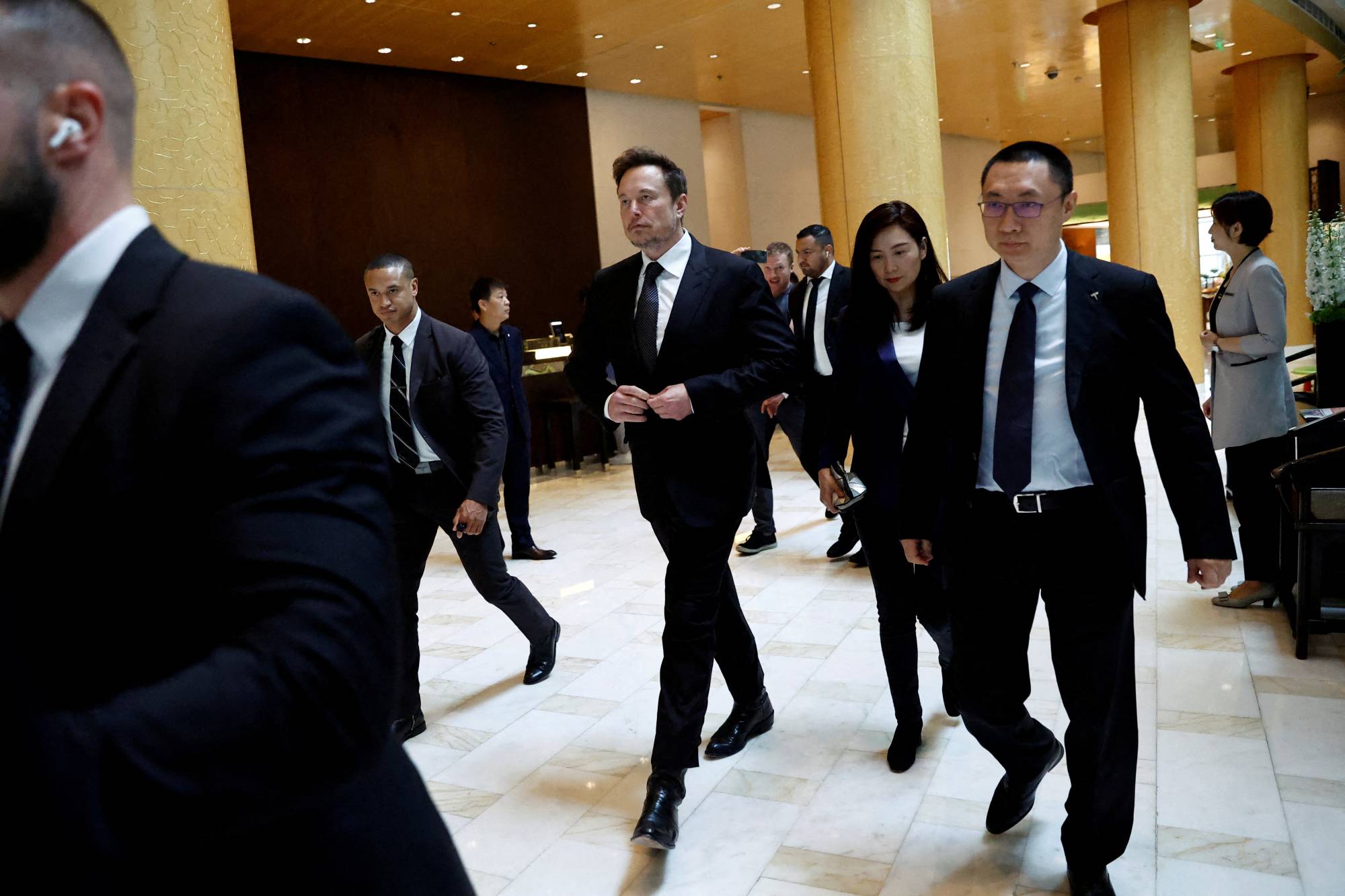 Tesla CEO Elon Musk leaves a hotel in Beijing on May 31. | REUTERS