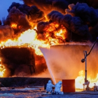 Firefighters work to extinguish a fire following shelling at an oil storage facility in the course of the Russia-Ukraine conflict in the town of Shakhtarsk, near Donetsk in Russian-controlled Ukraine, in October 2022. | REUTERS