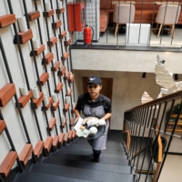 An employee serves an order at a Third Wave Coffee outlet in New Delhi. | REUTERS