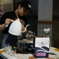 An employee shows brewing coffee with a Syphon coffee maker at a Third Wave Coffee outlet in New Delhi on May 30.  | REUTERS