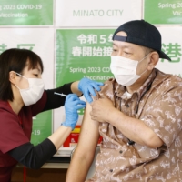 A man gets a COVID-19 vaccine shot in Tokyo on May 8 as the latest round of inoculation program for older people began the same day. | KYODO
