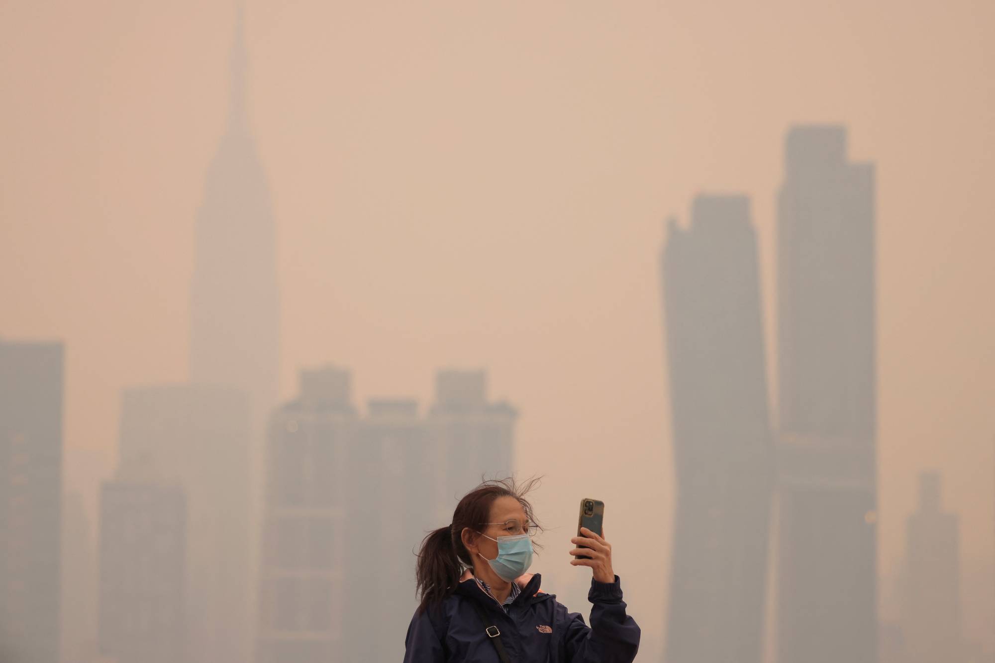 Haze and smoke caused by wildfires in Canada hang over the Manhattan skyline in New York on Wednesday. | REUTERS