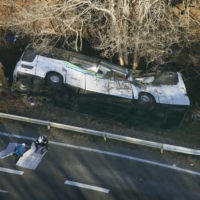 A ski bus overturned on a road in Karuizawa, Nagano Prefecture, in January 2016. | KYODO