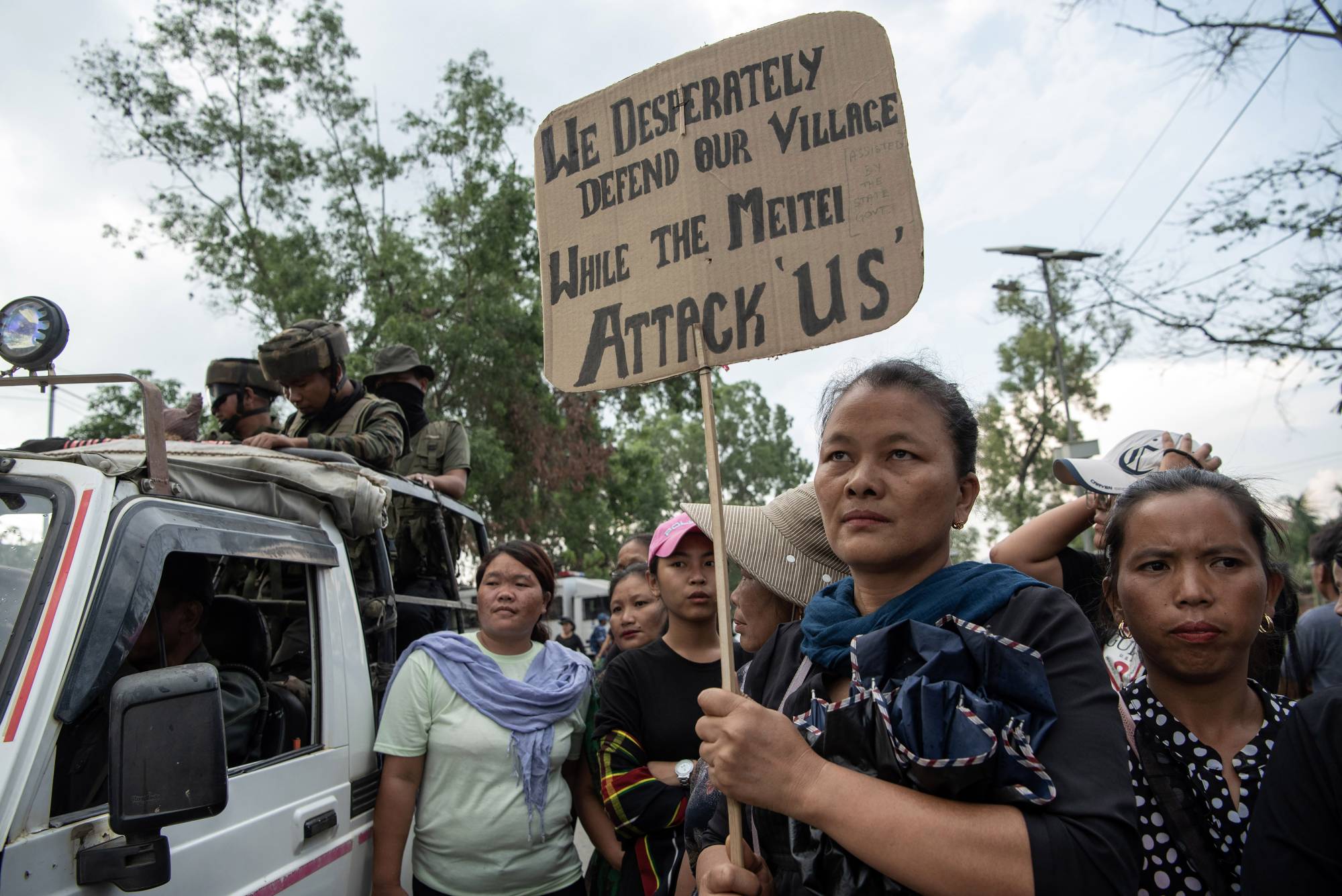 Tribal women, mostly Kukis, form a human chain along the route that the home minister Amit Shah would take during a visit, in Churachandpur, in the Indian state of Manipur, May 30. | Saumya Khandelwal / The New York Times