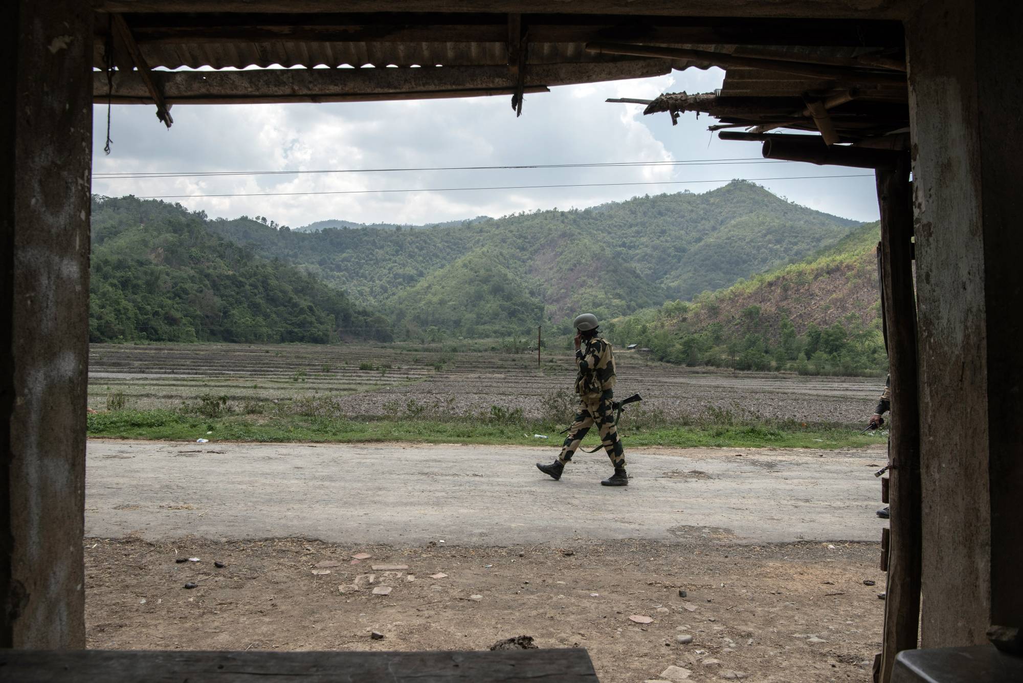 A member of the Border Security Force along the road to one of the last Meitei villages in Imphal East, in the Indian state of Manipur, on June 1. | Saumya Khandelwal / The New York Times
