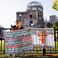 A Buddhist monk protests against nuclear weapons in front of the Atomic Bomb Dome at the Hiroshima Peace Memorial Park in Hiroshima, ahead of the Group of Seven summit, on May 17. | REUTERS