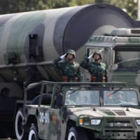 Chinese People\'s Liberation Army soldiers salute in front of nuclear-capable missiles during a massive parade in Beijing in 2009. | REUTERS