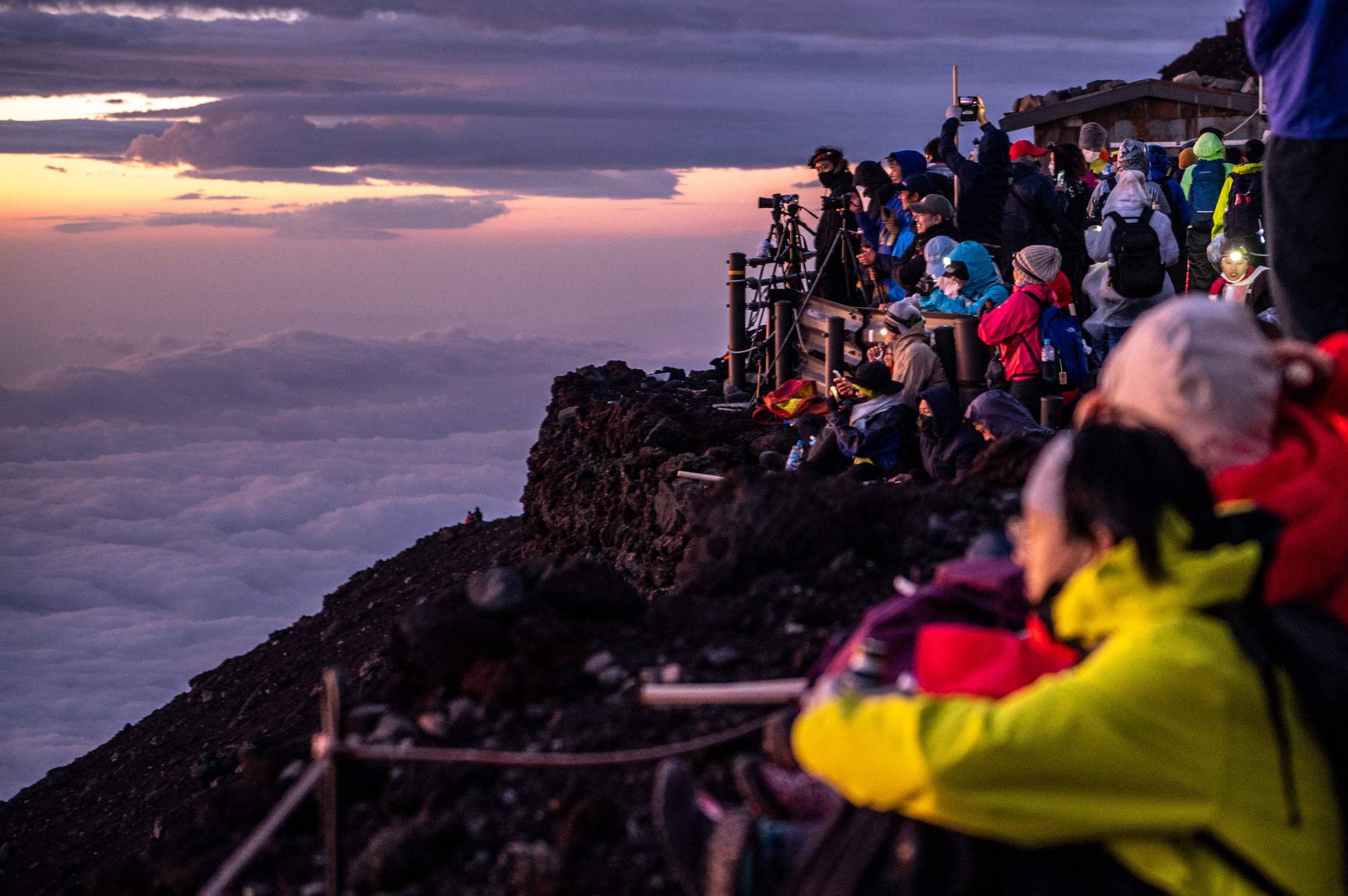 People watch the sunrise from the summit of Mount Fuji early on Aug. 15. | AFP-JIJI