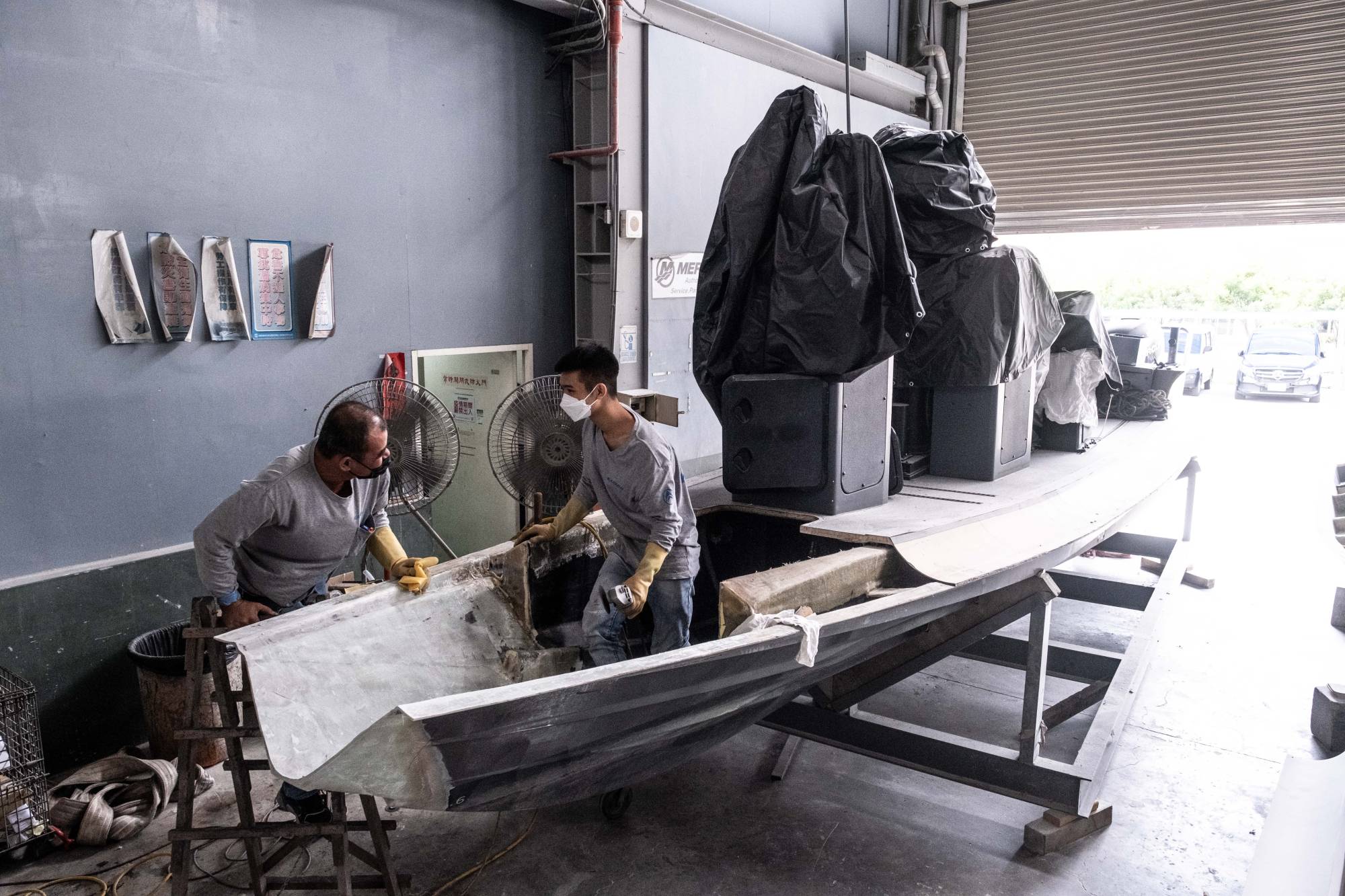 Workers repair a coast guard patrol boat whose nose had been sheared off at sea by a Chinese ship, in Pingtung City, Taiwan, in October 2022. | Lam Yik Fei / The New York Times