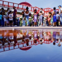 Children, accompanied by their parents, line up to receive a dose of the Pfizer-BioNTech COVID-19 pediatric vaccine in Ciudad Juarez, Mexico, in August 2022.  | REUTERS