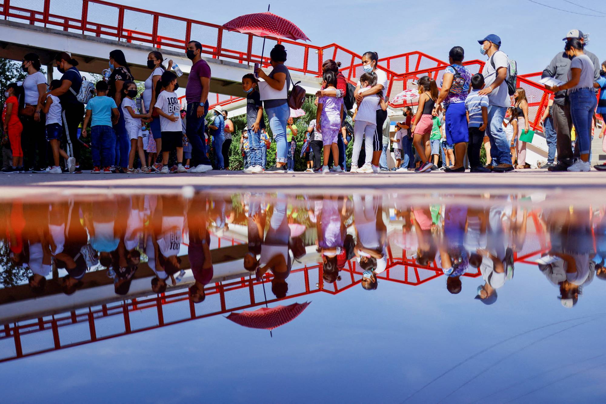 Children, accompanied by their parents, line up to receive a dose of the Pfizer-BioNTech COVID-19 pediatric vaccine in Ciudad Juarez, Mexico, in August 2022. | REUTERS
