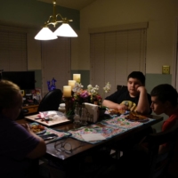 A family sits down for dinner without the father, who died from COVID-19 in December 2020 in Converse, Texas, in February 2022.  | REUTERS