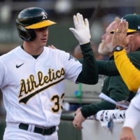 Athletics outfielder JJ Bleday celebrates with his teammates after hitting a three-run home run against the Rays in Oakland on Wednesday. | USA TODAY / VIA REUTERS