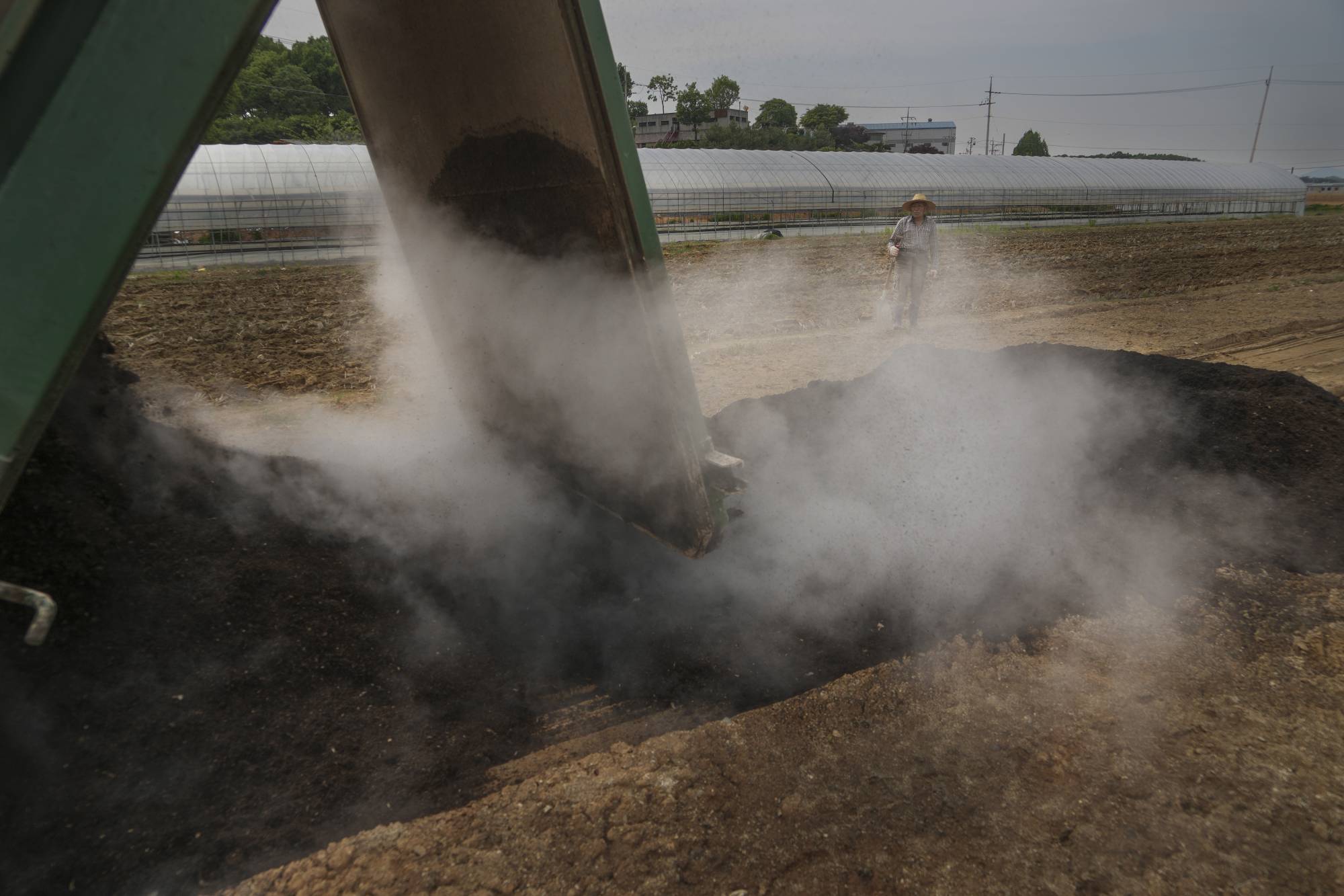 Fertilizer produced at Goyang’s biomass energy facility being delivered to a farm in Goyang-si, Gyeonggi Province, South Korea. Lettuce and bok choy are grown at the farm, in soil enriched by the fertilizer from the energy facility. | Chang W. Lee / The New York Times