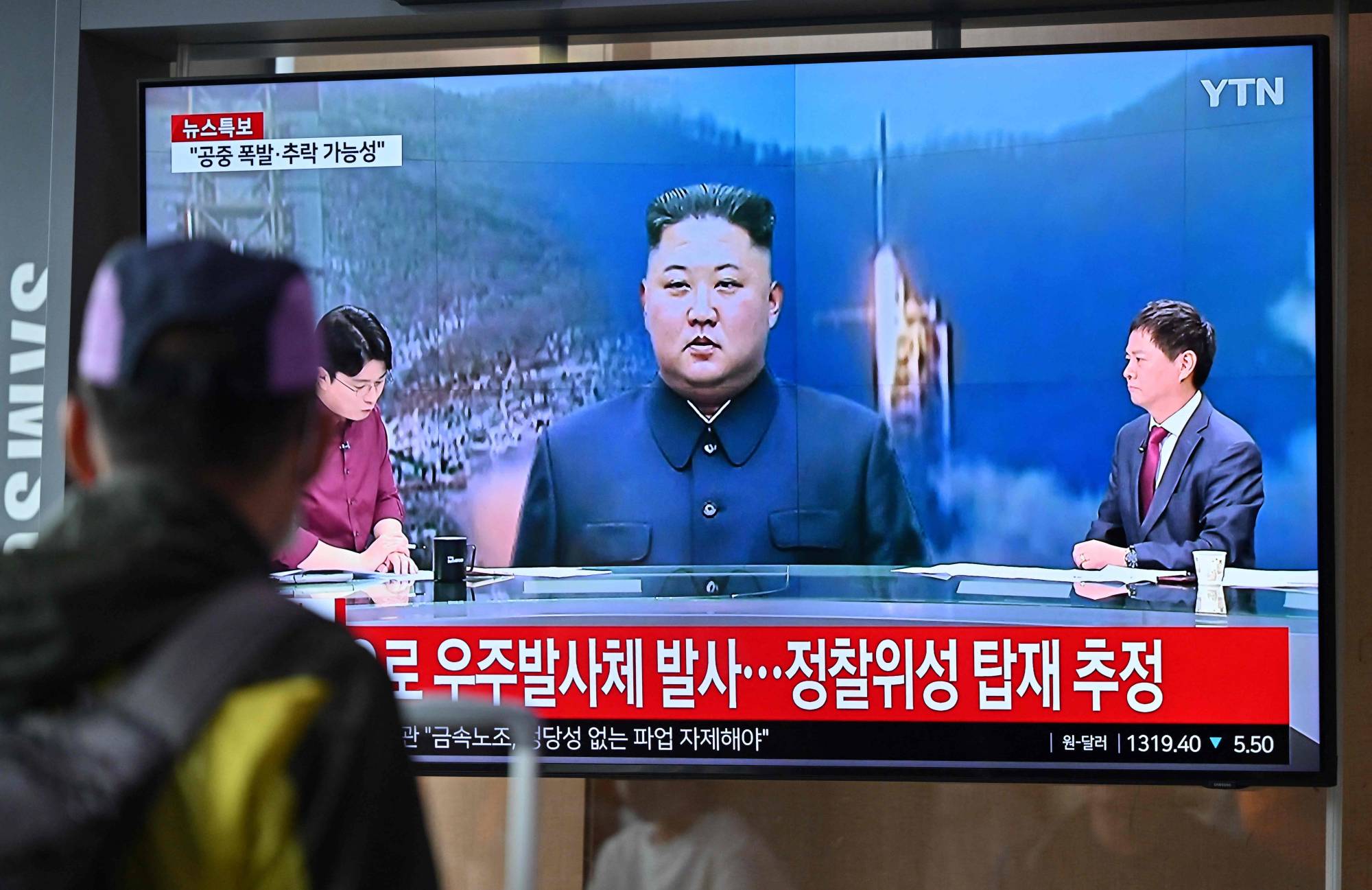 A television screen showing a news broadcast with file footage of North Korean leader Kim Jong Un, in Seoul on May 31 | AFP-JIJI