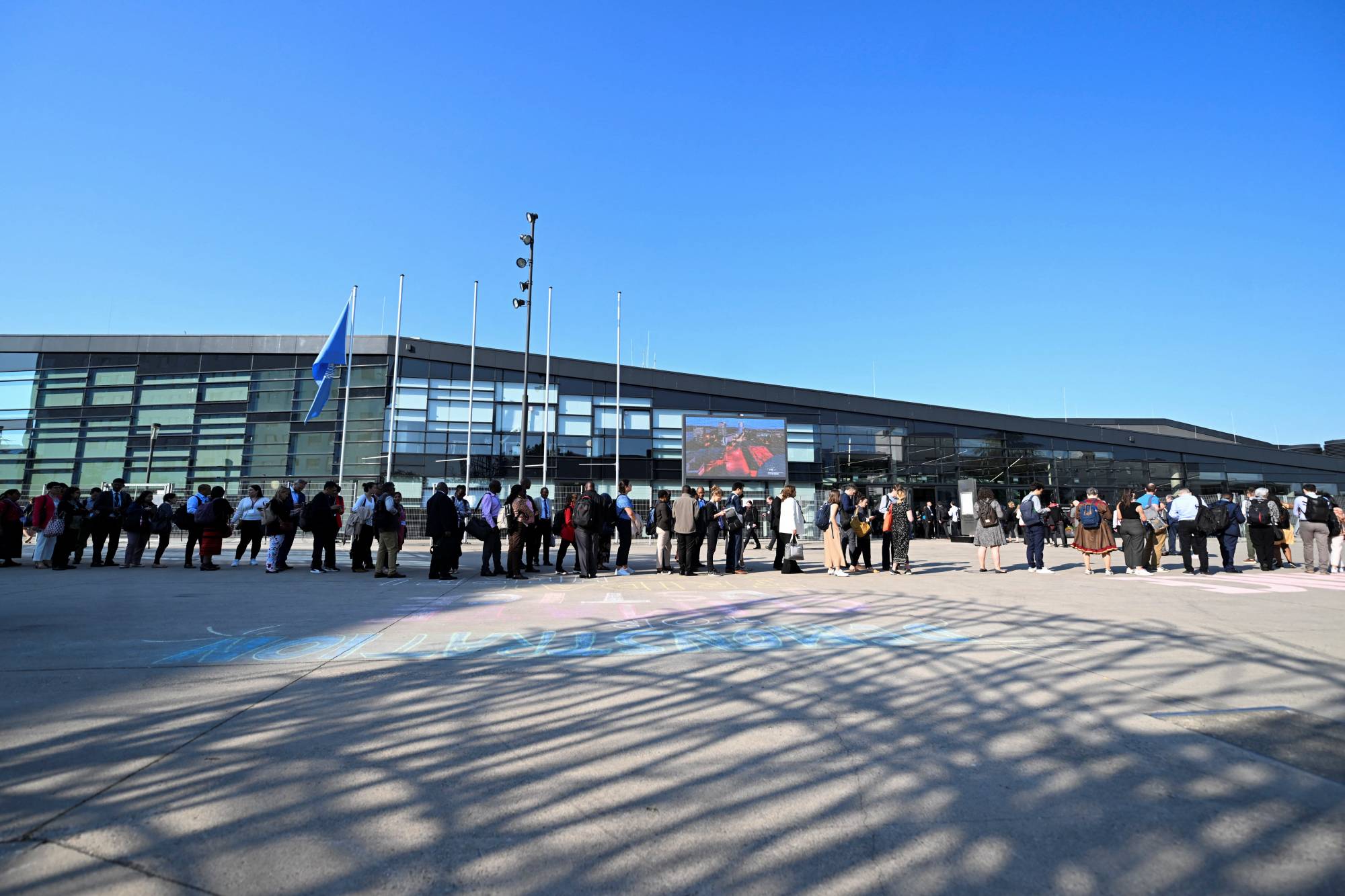 People wait in line to attend the Climate Change Conference in Bonn on June 6. | REUTERS 