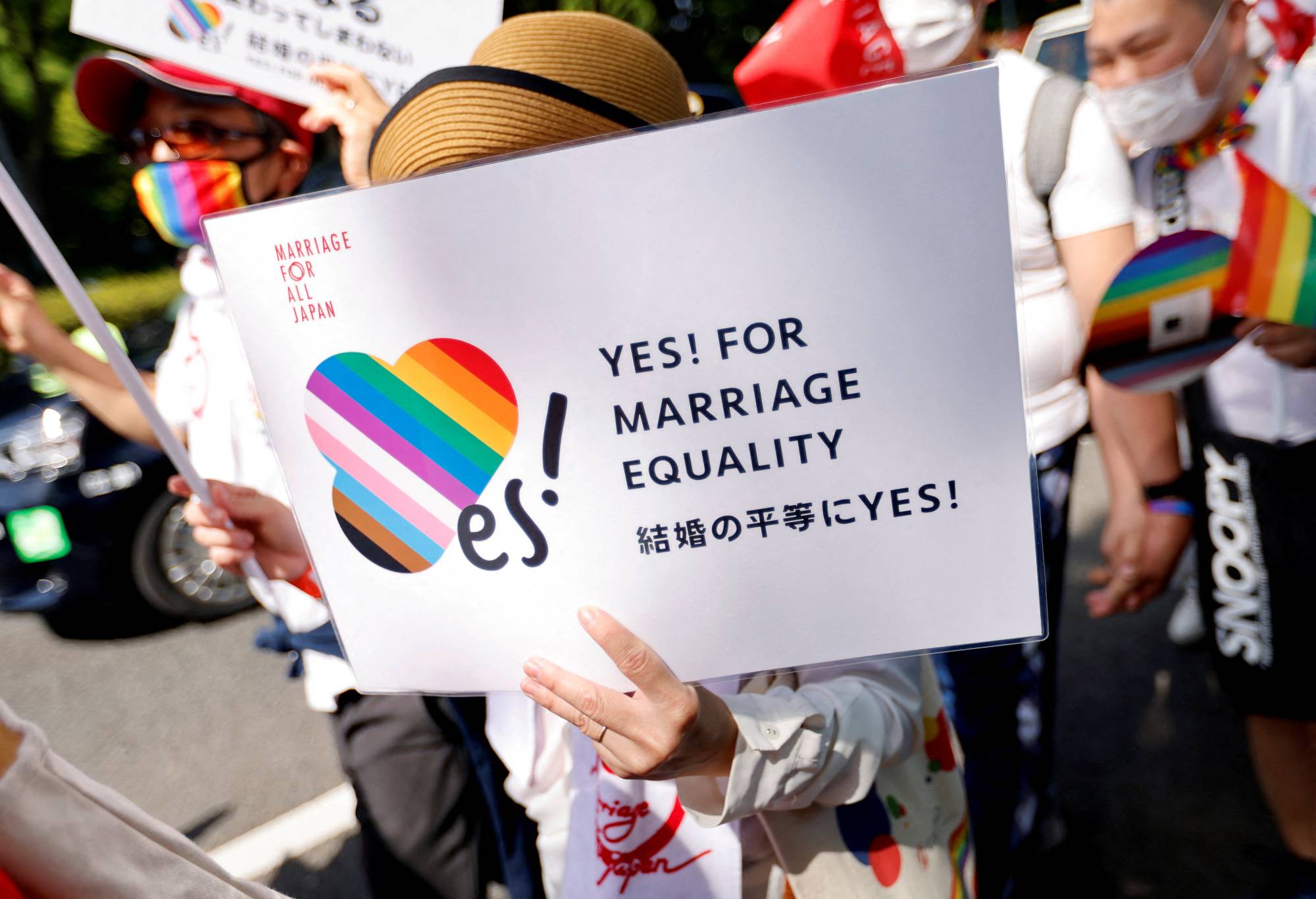 A participant holds a sign during the Tokyo Rainbow Pride parade, celebrating advances in LGBTQ rights and calling for marriage equality, in Tokyo in April. | REUTERS