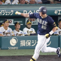The Tigers watch as Buffaloes outfielder Yutaro Sugimoto rounds the bases after hitting a home run at Koshien Stadium in Nishinomiya, Hyogo Prefecture, on Thursday. | KYODO