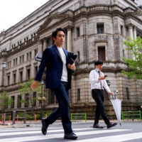 The Bank of Japan headquarters in Tokyo. The central bank decided Friday to maintain ultralow rates as widely expected, sticking to the view that it will require some time to achieve its 2% inflation target. | REUTERS