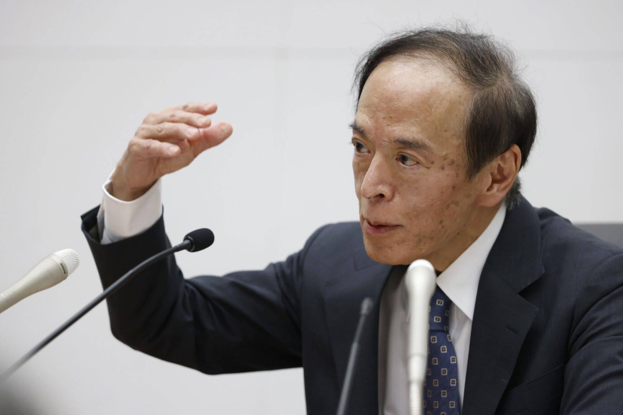 Kazuo Ueda, governor of the Bank of Japan, speaks during a news conference at the central bank's headquarters in Tokyo on Friday. | Bloomberg