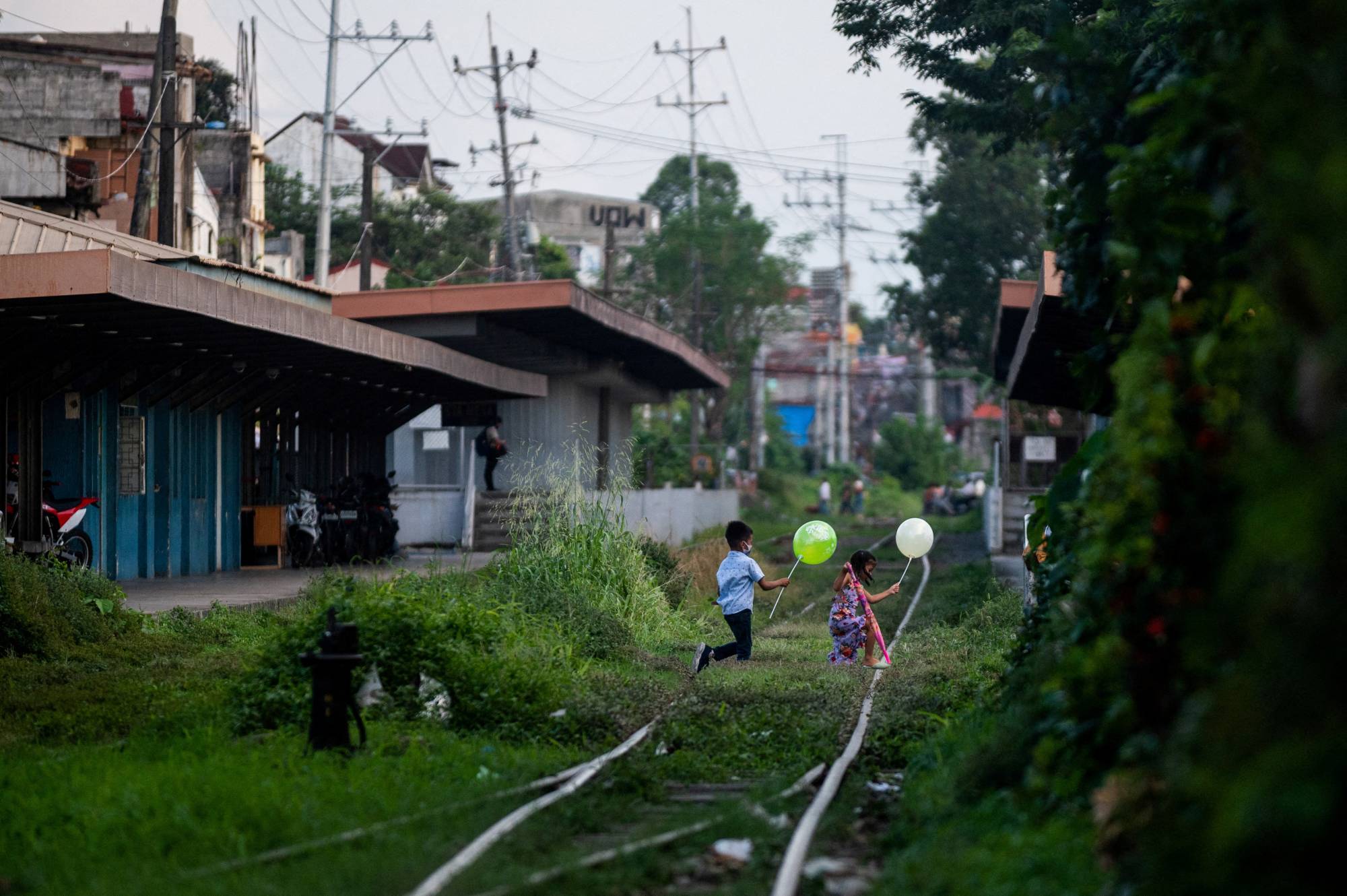 Children cross railroad tracks in Manila in November. The Philippines was named the world's top source of online child sexual exploitation content in a 2020 study by the International Justice Mission. | REUTERS