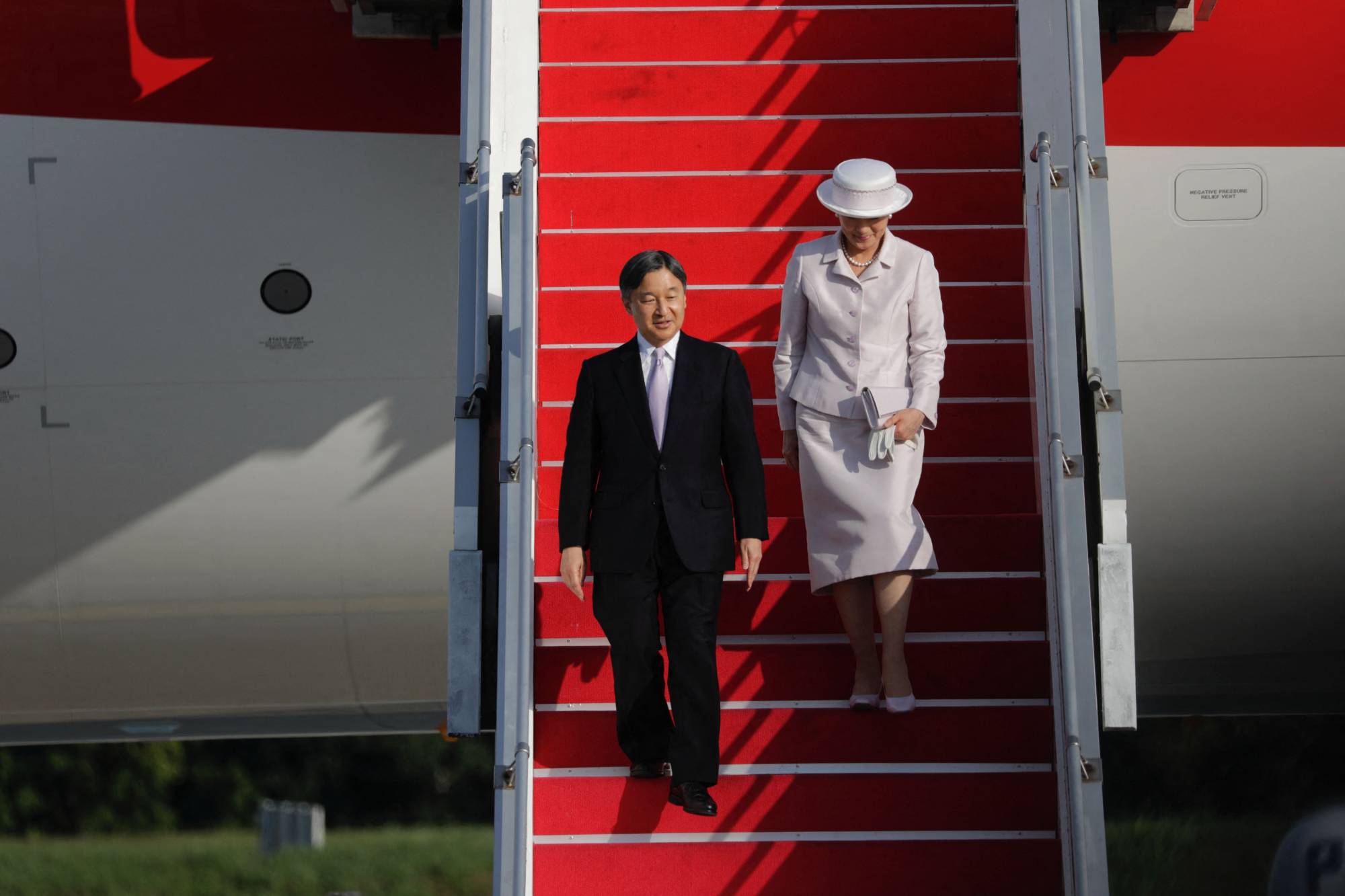 Emperor Naruhito and Empress Masako arrive at Soekarno-Hatta International Airport near Jakarta on Saturday. | POOL / VIA AFP-JIJI