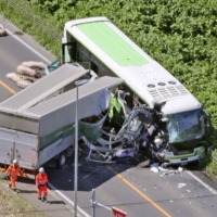 A truck and a bus crashed on a highway in the town of Yakumo, Hokkaido, on Sunday. | KYODO