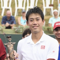 Kei Nishikori celebrates with the trophy after winning the Caribbean Open in Palmas Del Mar, Puerto Rico, on Sunday. | KYODO