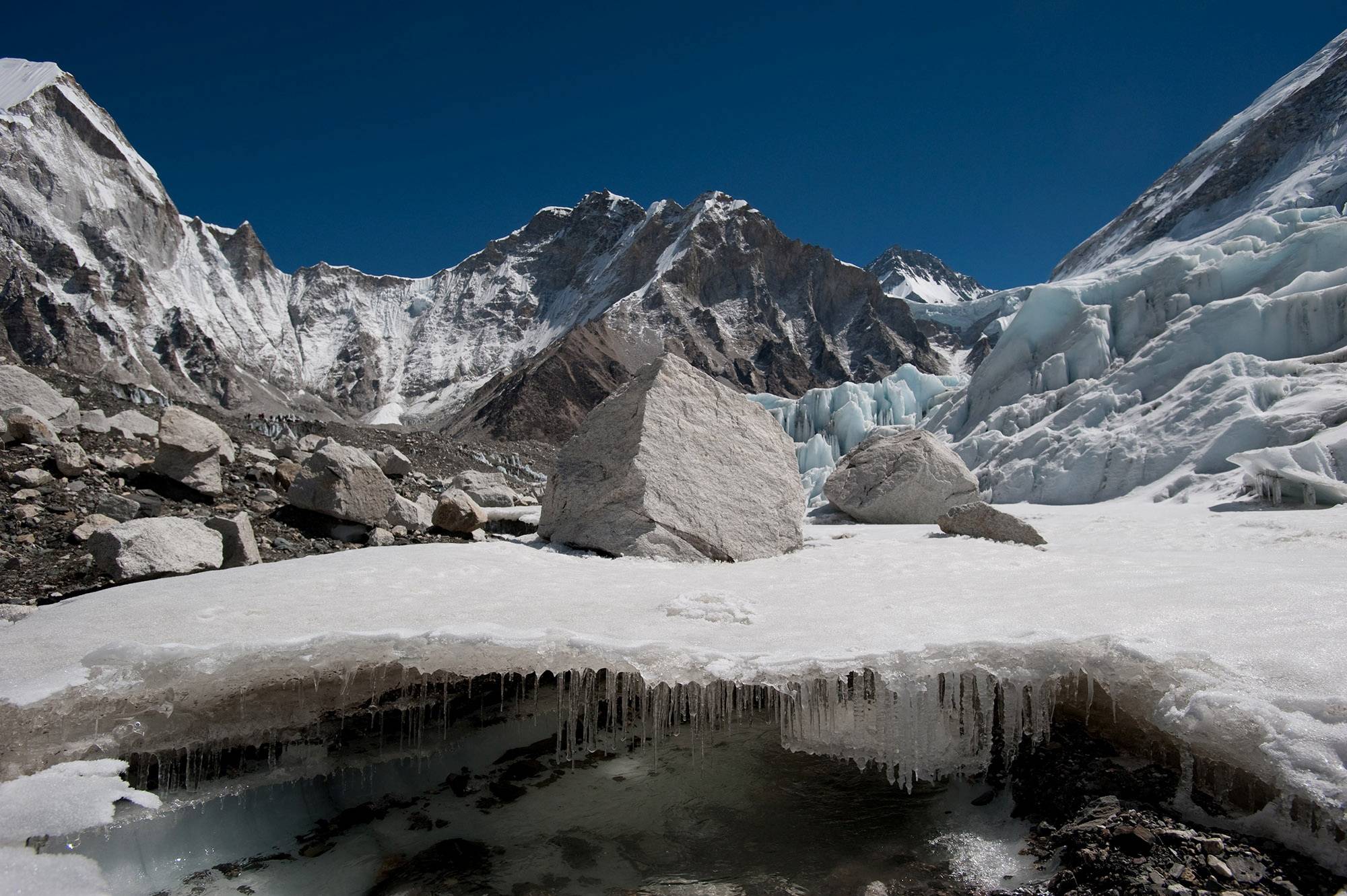 Water forms under Nepal's Khumbu glacier as the ice melts. At 1.5 degrees Celsius or 2 C of warming above preindustrial temperatures, glaciers across the entire region will lose 30% to 50% of their volume by the year 2100. | ICIMOD / VIA REUTERS 